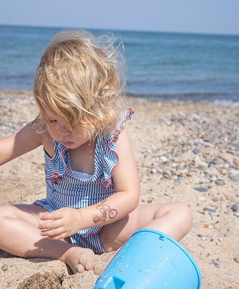 Little girl playing on the beach