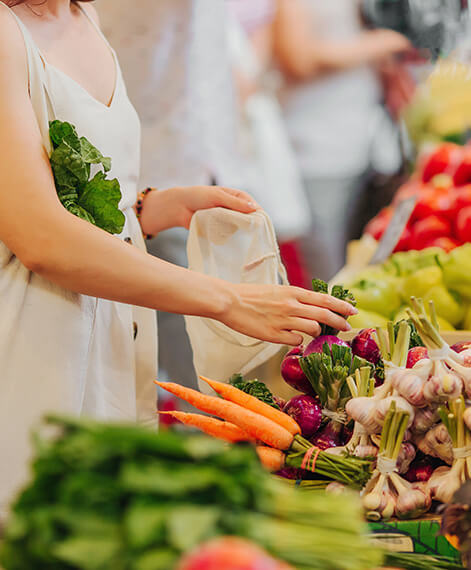 Woman at the grocery store picking produce
